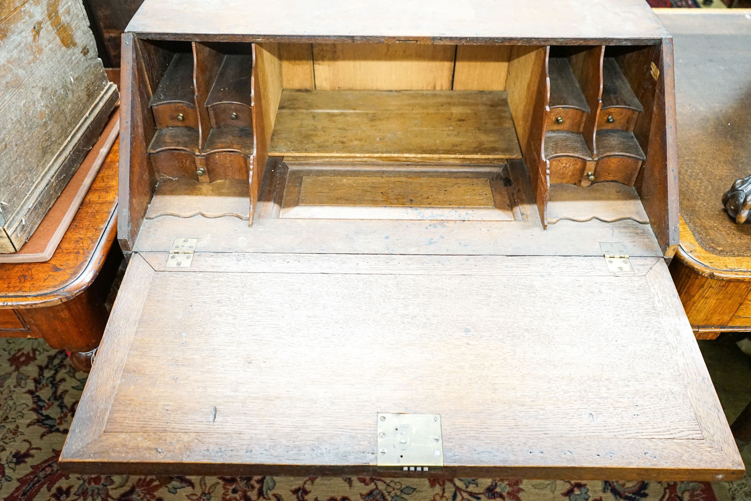An 18th century later carved oak bureau, width 91cm, depth 53cm, height 101cm